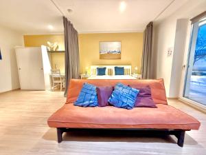 a living room with a couch with blue and purple pillows at VibeStudio A2- Central Vienna 1090 - 50m2 - Self Check-In - AC in Vienna