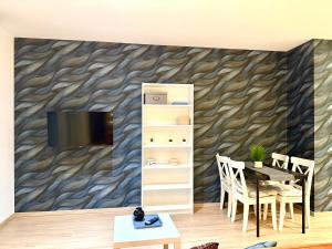 a living room with a table and a tv on a wall at VibeStudio A2- Central Vienna 1090 - 50m2 - Self Check-In - AC in Vienna