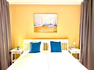 a bedroom with two beds with blue pillows at VibeStudio A2- Central Vienna 1090 - 50m2 - Self Check-In - AC in Vienna