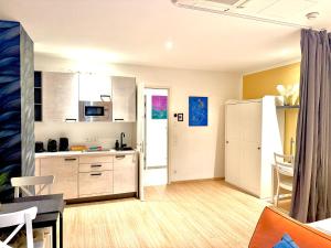 a kitchen with white cabinets and a table and chairs at VibeStudio A2- Central Vienna 1090 - 50m2 - Self Check-In - AC in Vienna