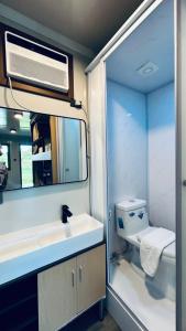 a bathroom with a sink and a mirror and a toilet at Duli Beach Farm Hostel in Duli +19 photos