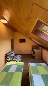 a room with two beds and a couch and a table at Pension Duel in Ústí nad Labem