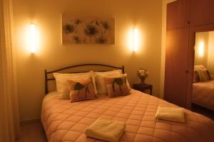 a bedroom with a large bed with two pillows at Sotiris Urban Stay in Xanthi