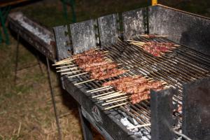 a grill with several different types of meat on it at Pallano in Bomba +13 photos