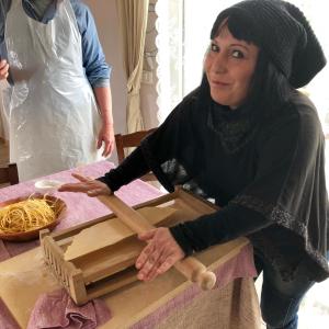 a woman sitting at a table with a box at Pallano in Bomba