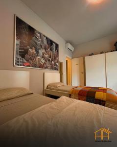 a hotel room with two beds and a painting on the wall at VVR6 Rooms by Homes in Ancona in Ancona
