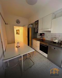 a kitchen with a white table and a refrigerator at VVR6 Rooms by Homes in Ancona in Ancona
