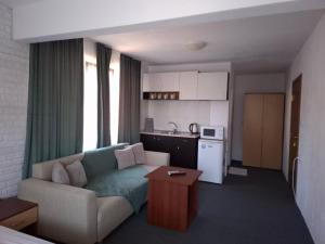 a living room with a couch and a kitchen at Ivet Guest Rooms - Obzor in Obzor +14 photos