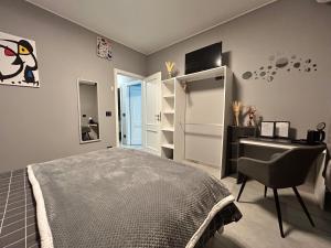 a bedroom with a bed and a desk and a chair at B&B Art in Silvi Marina