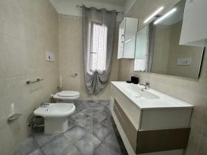 a bathroom with a sink and a toilet and a mirror at B&B Art in Silvi Marina +19 photos