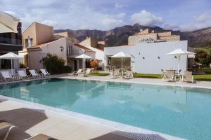 a large swimming pool in front of a building at Villas Marajo in Skala Potamias