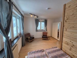 a bedroom with a bed and a wooden floor at Spiss 21 in Spiss