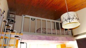 a chandelier hanging in a room with a crib at Studio chez Nathalie & Eric in Mérignac