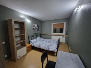 a bedroom with a bed and a table and chairs at Sitsi apartment in Tallinn