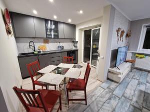 a kitchen and dining room with a table and chairs at Sitsi apartment in Tallinn