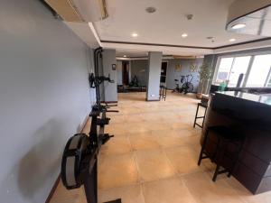a room with a wall with a tv and a room with chairs at Palawan Coliving - Palawan Coworking in Puerto Princesa City