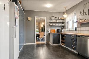 a kitchen with blue cabinets and a counter top at Den Gamle Apotekergaard in Høng