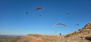 four kites flying in the sky over a mountain at Villa Zaïtoun in Aït Ourir