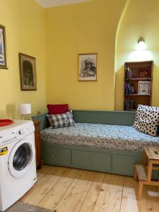 a bedroom with a bed and a washing machine at Art Studios Elsor in Burgas
