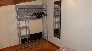 a room with a rack of shoes and a mirror at Studio chez Nathalie & Eric in Mérignac