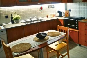 a kitchen with a table with two chairs and a sink at Sotiris Urban Stay in Xanthi