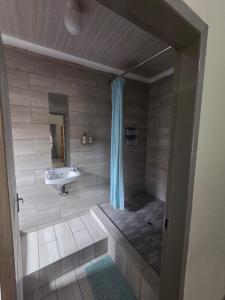 a bathroom with a tub and a sink at The Second Tranquilo in Ermelo