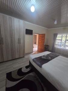 a bedroom with a large bed and wooden cabinets at The Second Tranquilo in Ermelo +8 photos