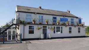 a white building with potted plants on top of it at The Riverside in Spalding
