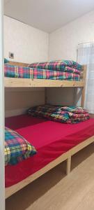 a bedroom with two bunk beds and a red sheet at Casacocco' - Agri Host in San Ginesio
