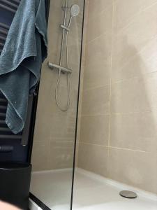 a shower with a shower head in a bathroom at Location de Chambre SDB Cuisines in Charleroi