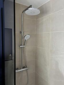 a shower with a shower head in a bathroom at Location de Chambre SDB Cuisines in Charleroi