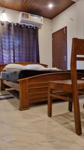 a bedroom with a wooden bed and a window at Hotel Arena in Mahe