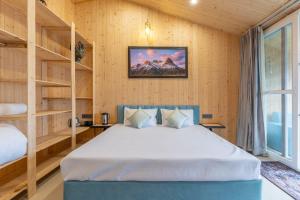 a bedroom with a bed in a room with wooden walls at River and Roots Resort, Riverside Boutique Stay , Bonfire, Scenic Views in Dehradun