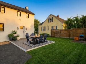 a patio with chairs and a table in a yard at Sleek Modern Villa - Centrally Located in Wilmington