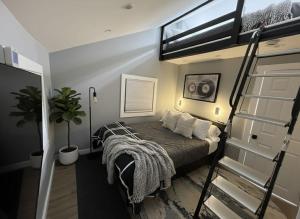 a bedroom with a bed and a ladder to a loft at Sleek Modern Villa - Centrally Located in Wilmington