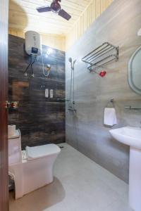 a bathroom with a toilet and a sink at River and Roots Resort, Riverside Boutique Stay , Bonfire, Scenic Views in Dehradun +24 photos