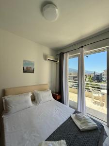 a bedroom with a bed and a large window at Escape at Chalandri Athens in Athens