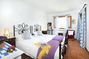 a bedroom with a large white bed and a window at Villa Maina by Villa Plus in El Port +23 photos