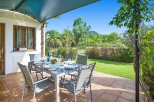 a table and chairs on a patio at Villa Maina by Villa Plus in El Port