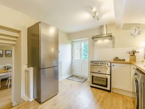 a kitchen with a stainless steel refrigerator and a table at 3 Bed in Ripon oc-83728 in Healey +16 photos