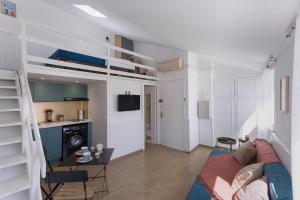 a living room with bunk beds and a kitchen at Studio André - Palais & plage, clim in Cannes +22 photos