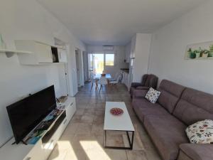 a living room with a couch and a tv at AR El ENCÍN TR-CC-00592 in Valdencin