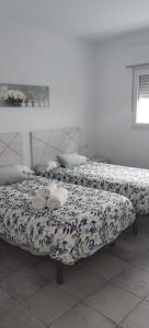 two beds sitting next to each other in a room at AR El ENCÍN TR-CC-00592 in Valdencin +5 photos