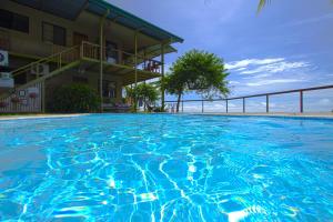 a large swimming pool in front of a building at Santa Teresa Surf Vista Villas in Santa Teresa Beach +62 photos