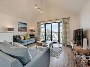 a living room with a couch and a table at 2 Bed in Bideford oc-91748 in Northam