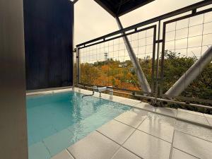 a swimming pool on top of a building at 熱海ブレスアネックス in Atami