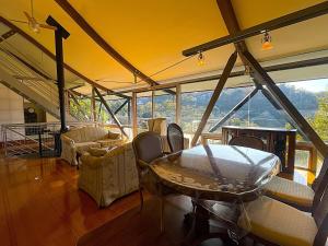 a living room with a table and a large window at 熱海ブレスアネックス in Atami