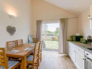 a kitchen and dining room with a table and chairs at 2 Bed in Cowes oc-73374 in Gurnard
