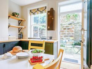 a kitchen with a table with a bowl of tomatoes on it at 4 Bed in Harrogate oc-73424 in Harrogate
