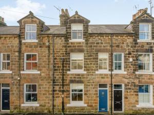 an old brick house with blue doors and windows at 4 Bed in Harrogate oc-73424 in Harrogate